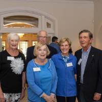 Group of seven standing together and posing for photo